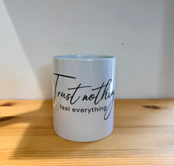 Cup with quotes-Trust nothing feel everything-